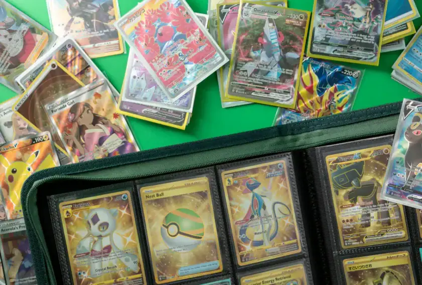 Pokémon trading cards displayed with booster packs and collection binder for beginners.